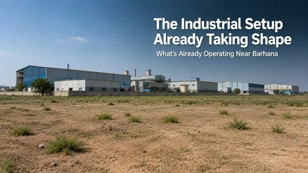 Established factory sheds beside open land representing the existing industrial setup near Barhana